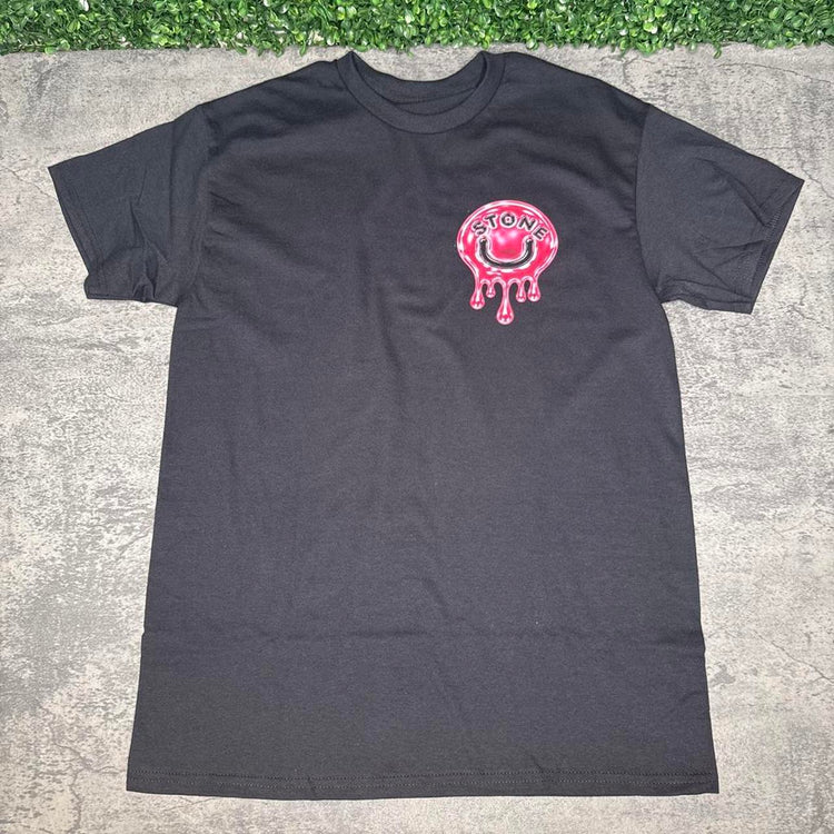 Black tee with a small pink STONE dripping smile graphic on the chest