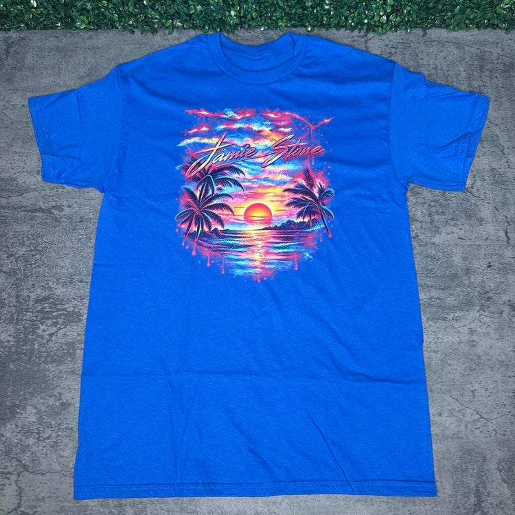 Royal blue Jamie Stone tee with tropical sunset and palm tree artwork