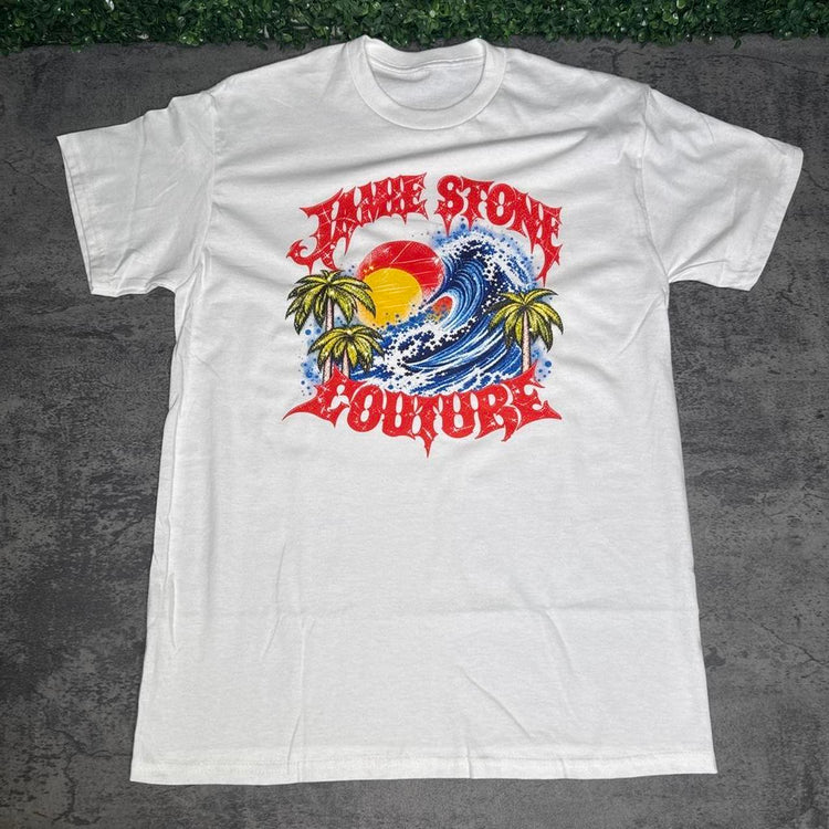 Dark navy Jamie Stone floral graphic tee on concrete with grass above
