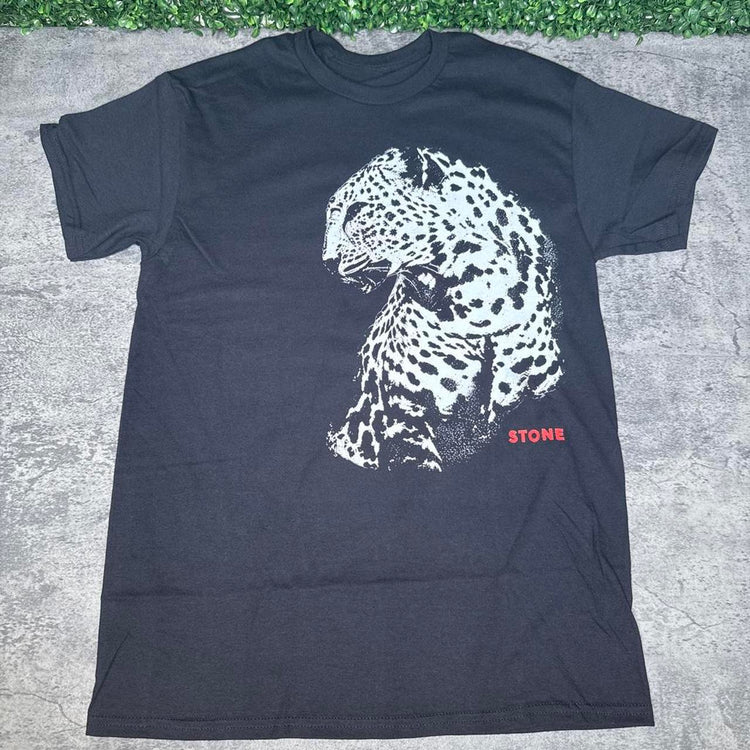 Black cheetah crewneck sweatshirt flat lay on concrete with grass above