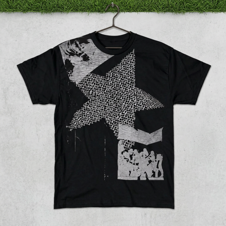 Black monochrome star collage tee on a hanger against concrete with grass above
