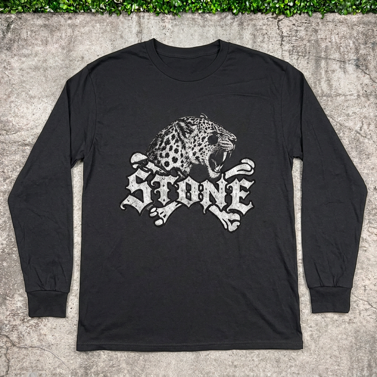STONE leopard long-sleeve tee flat lay on concrete with grass above