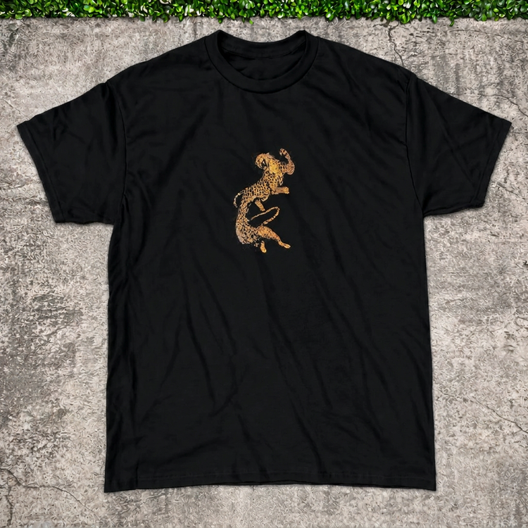Twin Cheetah Tee main photo with AI-edited concrete and greenery backdrop