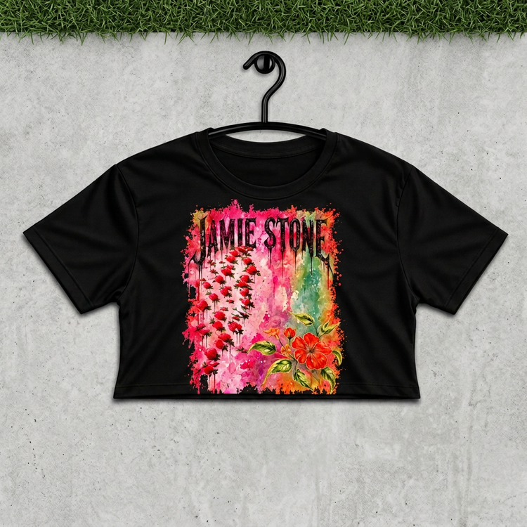 Jamie Stone floral crop on a black hanger against concrete with grass above