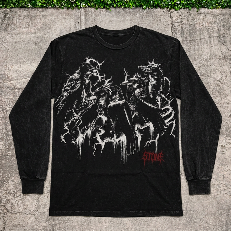 Raven thorn long-sleeve tee flat lay on concrete with grass above