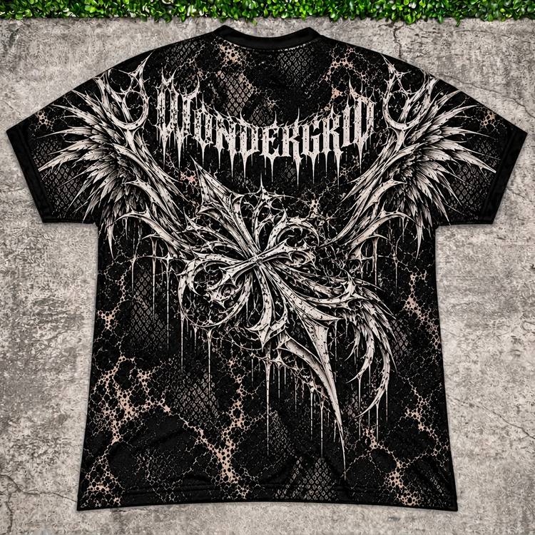 Winged Crest Tee main photo with AI-edited concrete and greenery backdrop