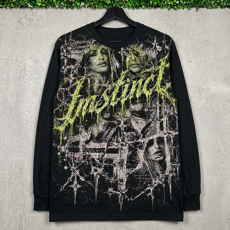 Black Instinct Thorn long sleeve on a hanger against concrete