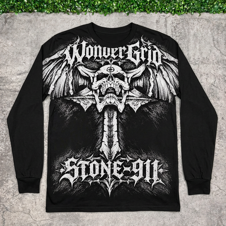 Black Skullwing long sleeve flat lay on concrete with grass above