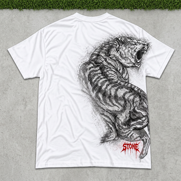 White STONE tiger tee flat lay on concrete with green grass above