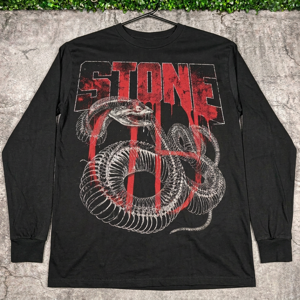 STONE snake bones long-sleeve tee on a hanger against concrete with grass above