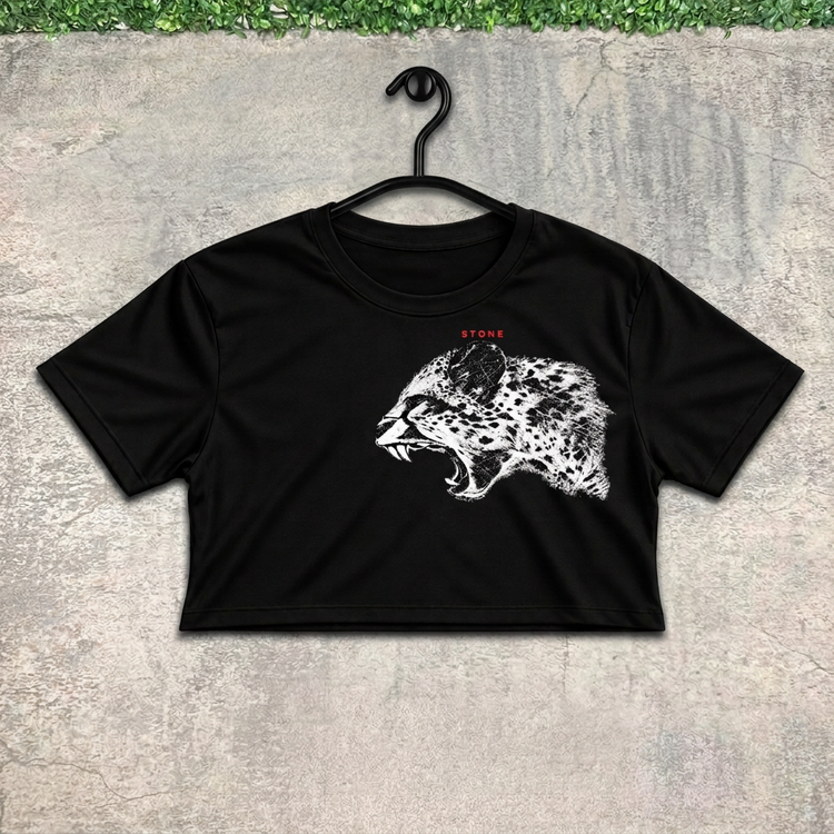Roaring leopard crop on a black hanger against concrete with grass above
