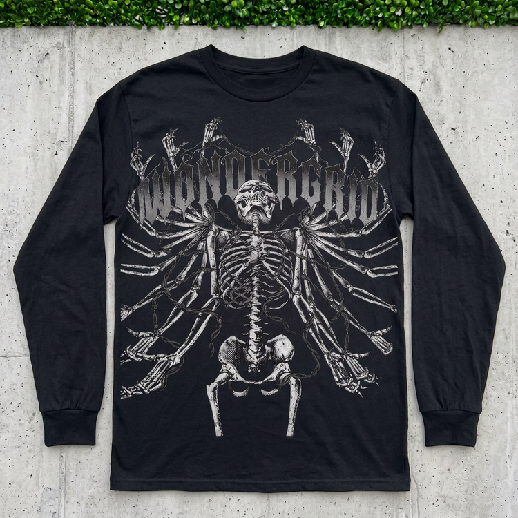 Black Bonebound Skeleton long sleeve flat lay on concrete with grass above