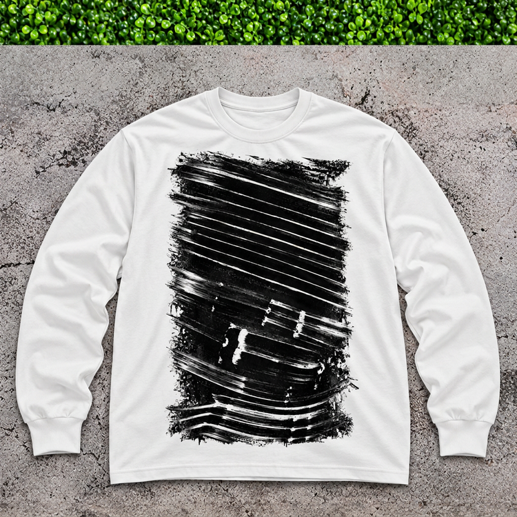 White brushstroke long-sleeve shirt flat lay on gray concrete with a thin green grass strip