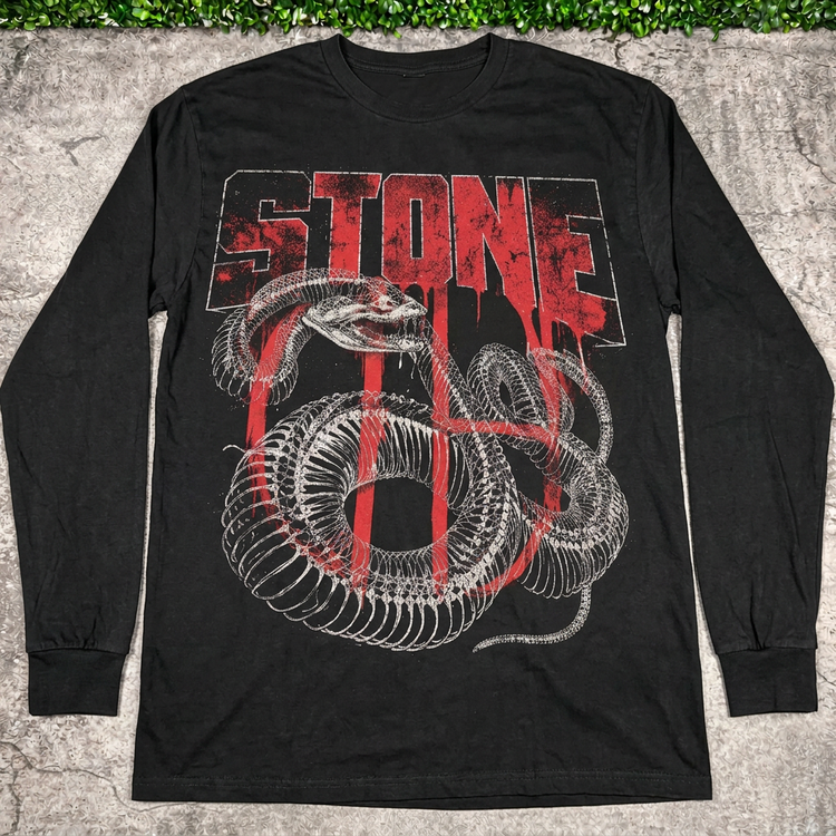 STONE snake bones long-sleeve tee flat lay on concrete with grass above