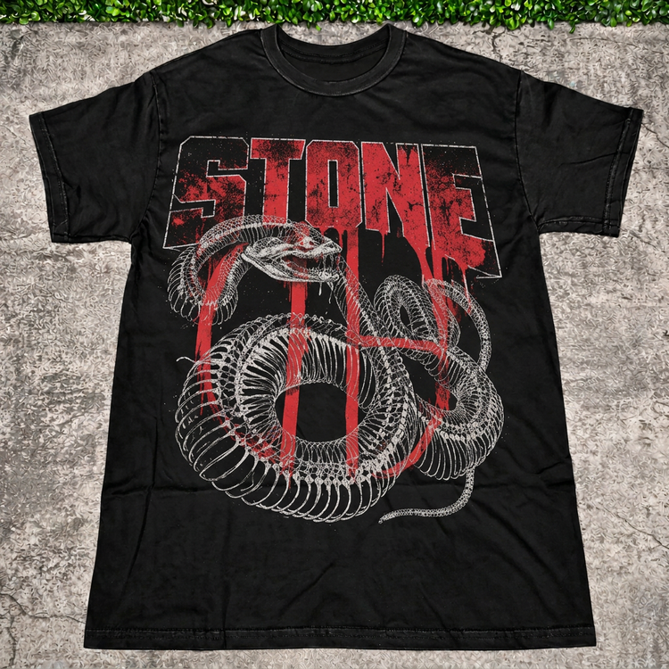 STONE Snake Bones Tee with AI-edited concrete and greenery backdrop