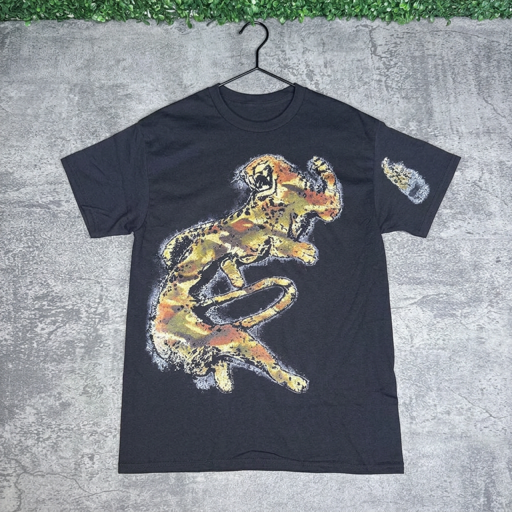 Black white wolf graphic tee on a hanger against concrete with grass above