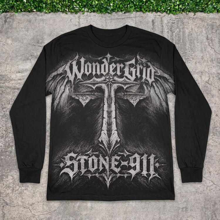 STONE-911 winged cross long-sleeve tee flat lay on concrete with grass above